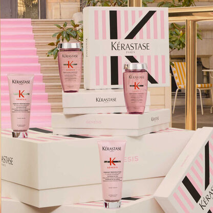Immagine di prodotti per capelli Kerastase Genesis su scatole eleganti, con sfondo di scale e decorazioni in stile parigino.