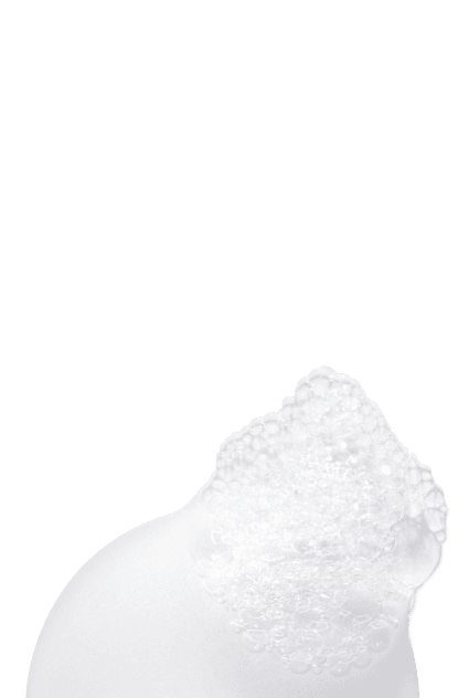 Primo piano di una texture cremosa bianca e ricca, che illustra un prodotto per capelli nutriente.