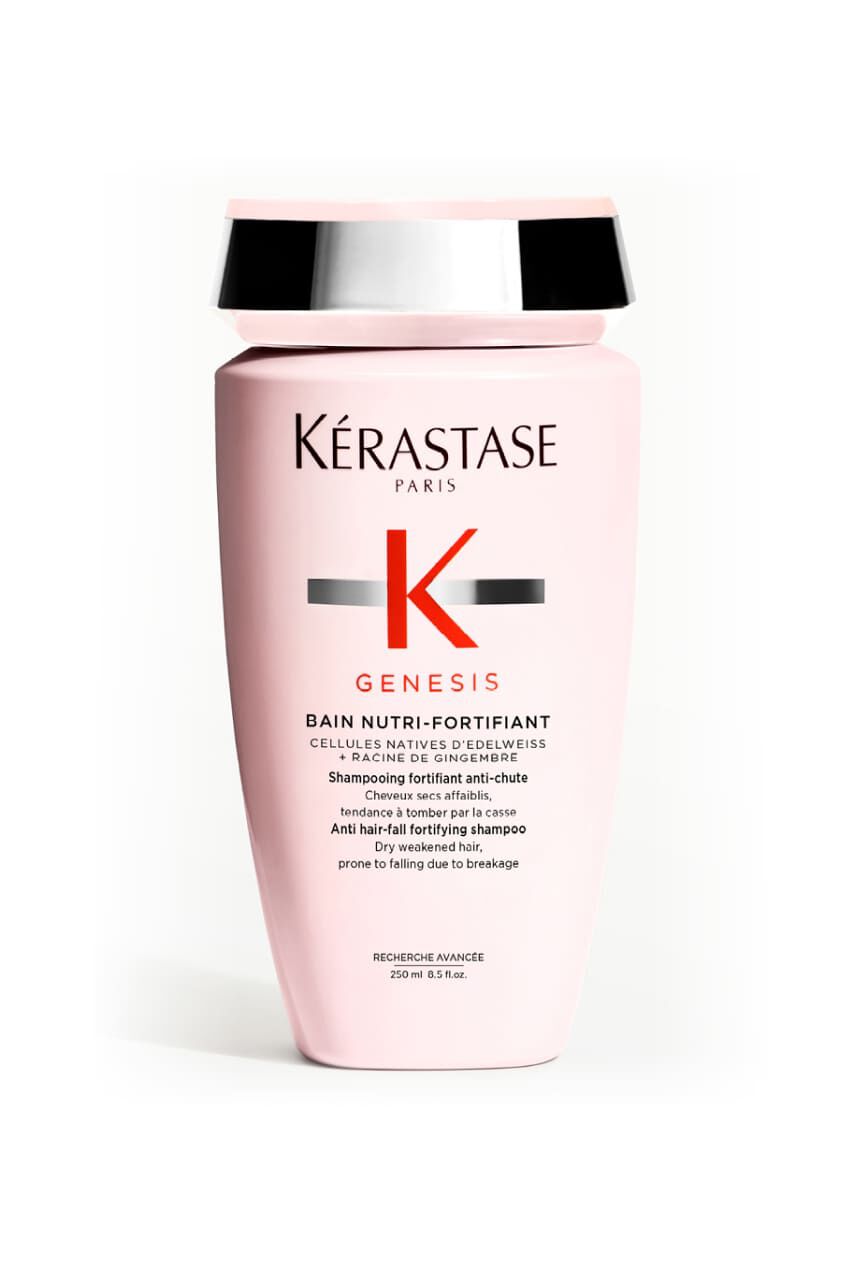 Bottiglia rosa opaca dello shampoo Kerastase Genesis Bain Nutri-Fortifiant per capelli secchi e indeboliti.