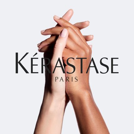 Two hands, one light-toned and one dark-toned, are interlocked in a gesture symbolizing unity, with the Kerastase Paris logo displayed prominently below.
