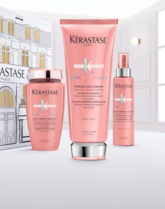 Flacone di siero Kerastase Paris Glaze Drops con gocce che cadono.