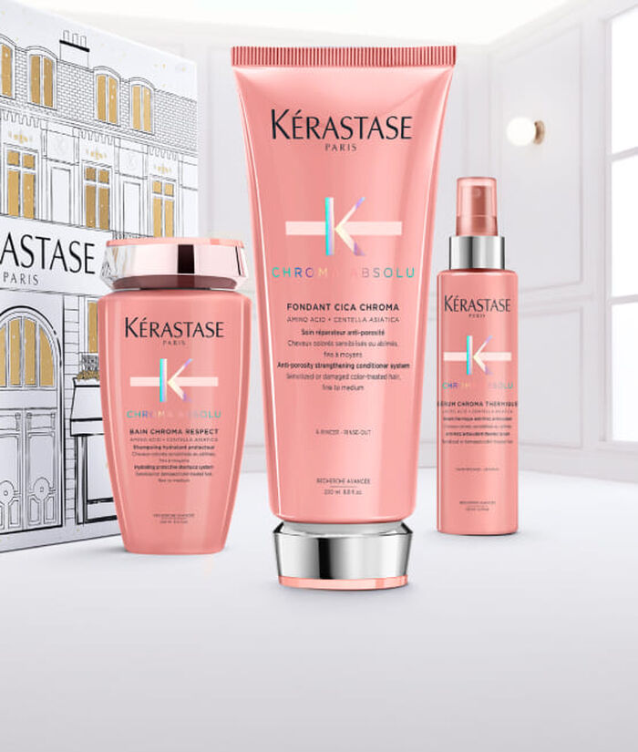 Flacone di siero Kerastase Paris Glaze Drops con gocce che cadono.