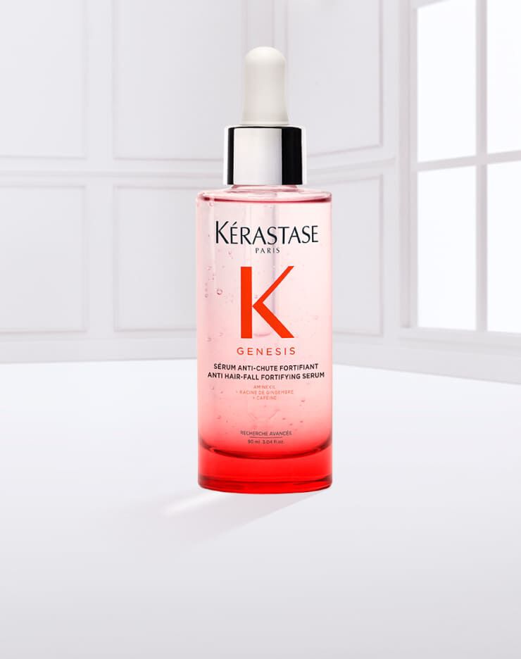 Siero per capelli Kerastase Genesis, in bottiglia trasparente con contagocce, su sfondo chiaro.