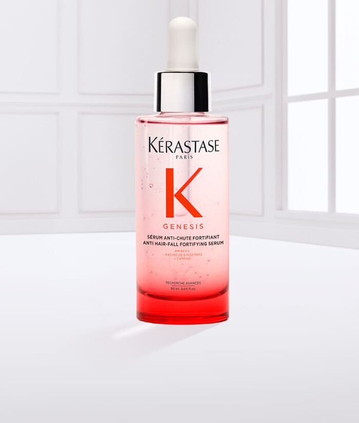 Siero per capelli Kerastase Genesis, in bottiglia trasparente con contagocce, su sfondo chiaro.