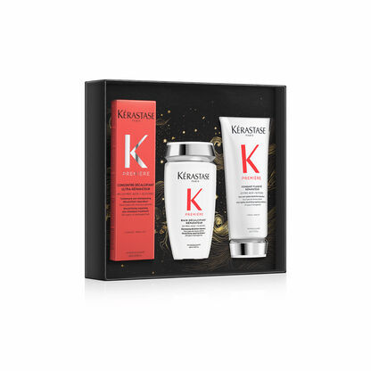 Set di prodotti Kerastase, inclusi uno shampoo, un balsamo e un trattamento per capelli, presentato in una elegante confezione nera.