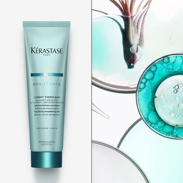 El ciment thermique Resistance Kerastase se coloca sobre una superficie blanca.