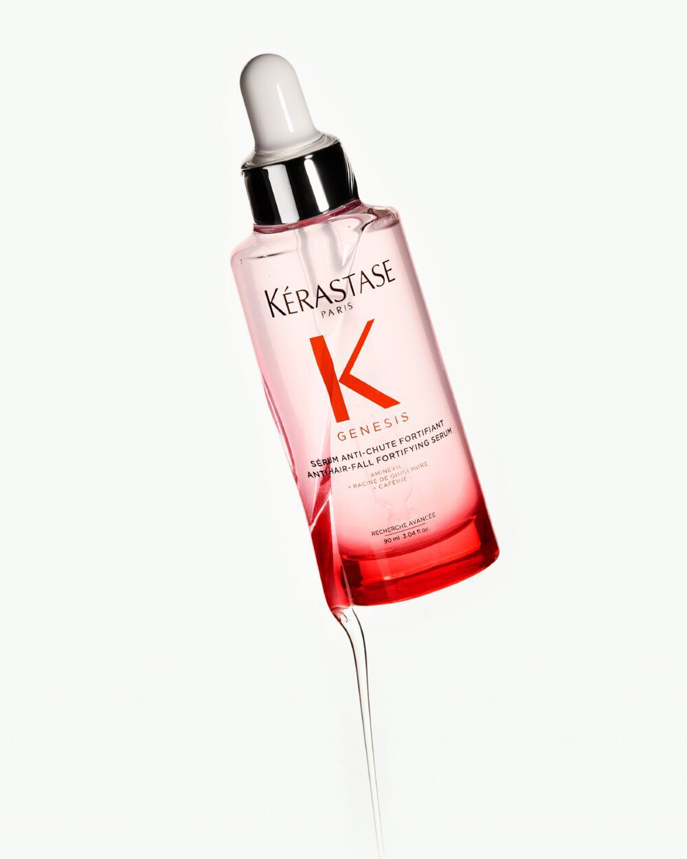 Siero per capelli Kerastase Genesis, in bottiglia trasparente con contagocce, su sfondo chiaro.