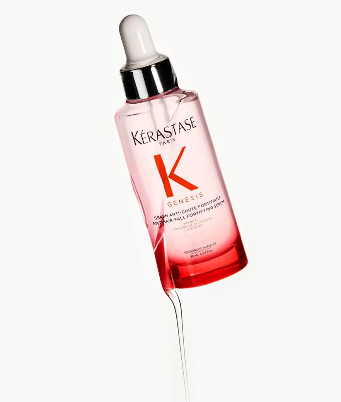 Siero per capelli Kerastase Genesis, in bottiglia trasparente con contagocce, su sfondo chiaro.