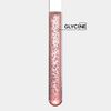 Provette di laboratorio con liquido rosa e bolle, etichettata \'GLICINA\'. Elemento chimico in un contesto scientifico.