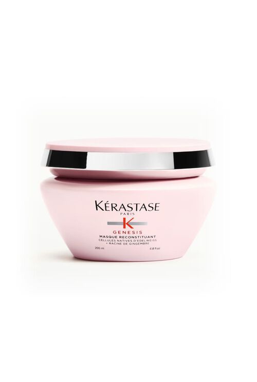 Vaso rosa della maschera Kerastase Genesis Masque Reconstituant, posizionato su una superficie bianca.