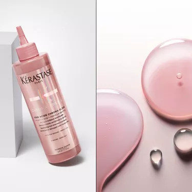 Il fondant soin acide chroma gloss Kerastase e posizionato in piedi su una base trasparente.