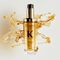 Il nuovo Elixir Ultime ricaricabile e decorato con bellissime gocce di olio per capelli dalla texture dorata.