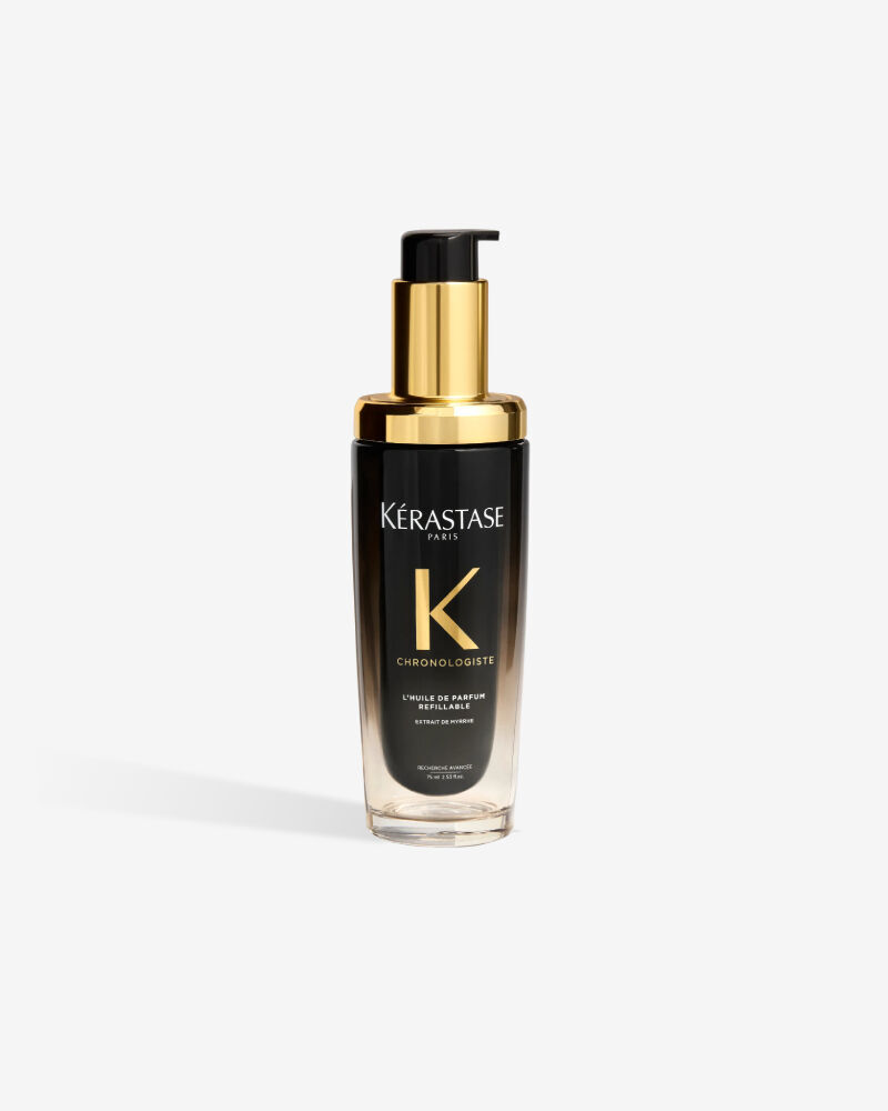 Olio per capelli ricaricabile Kerastase Chronologiste L'Huile de Parfum in un lussuoso flacone sfumato dal nero al trasparente con erogatore dorato.