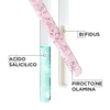 Tre provette con sostanze: acido salicilico blu, piroctone olamina bianco e bifidus, su sfondo bianco.