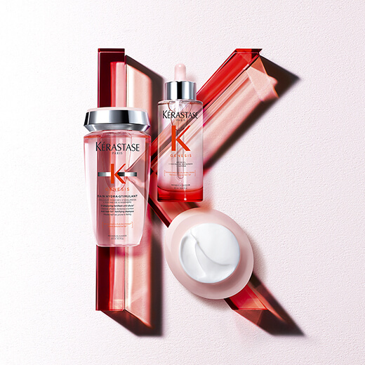 Immagine di prodotti Kérastase Genesis: flacone con gocce, crema e shampoo, su uno sfondo elegante e minimalista.