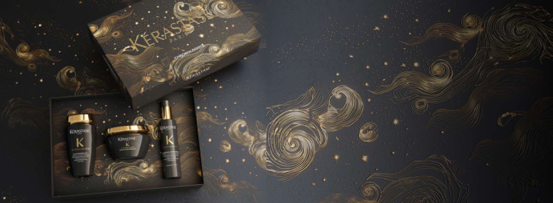 Scatola di prodotti per capelli Kerastase con design elegante su sfondo scuro e motivi dorati.