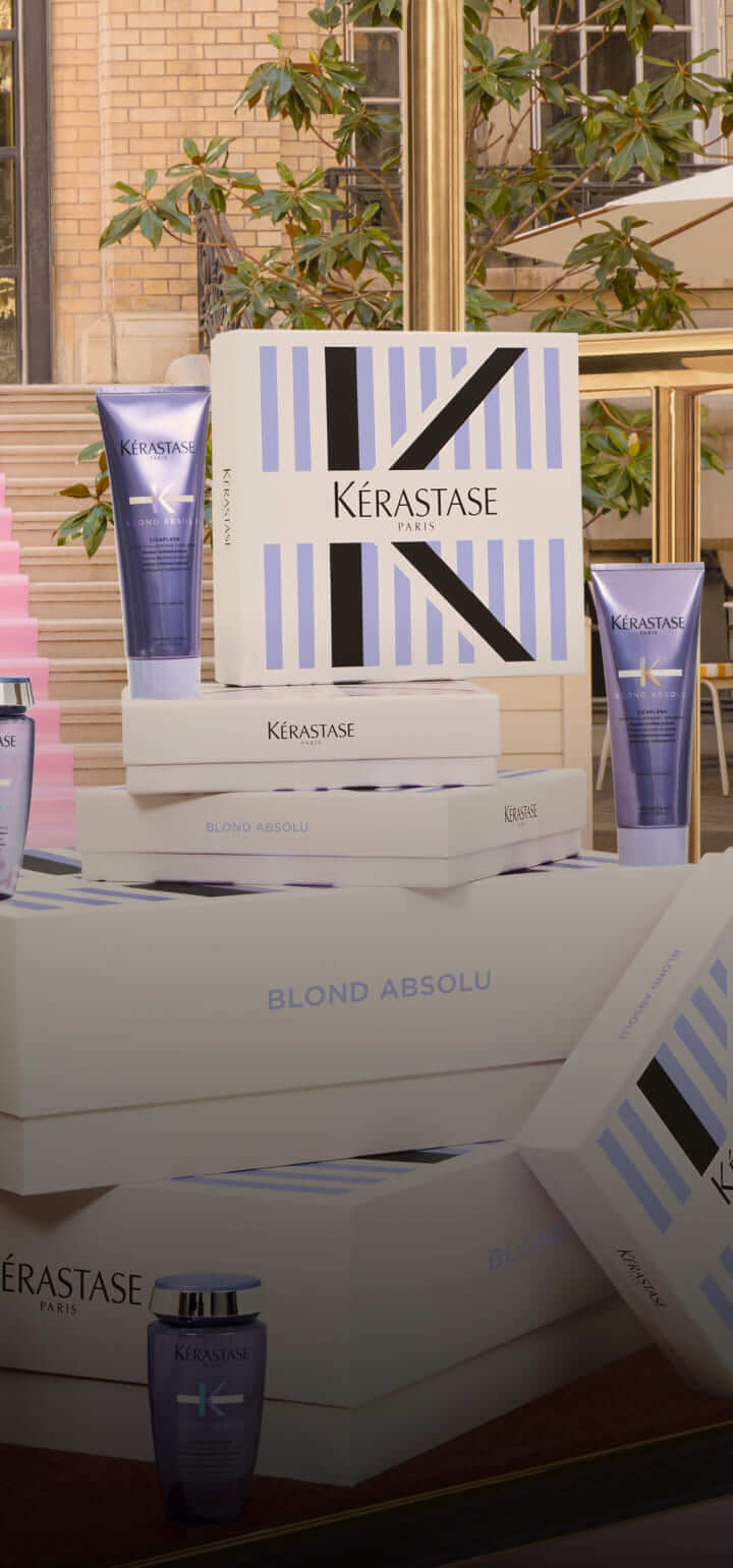 Immagine di prodotti Kérastase Blond Absolu in confezioni eleganti, esposti in un ambiente moderno e luminoso.