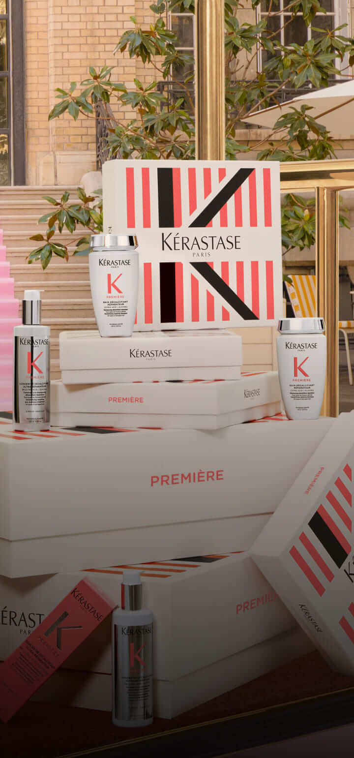 Scatole e prodotti Kérastase in un elegante ambiente, evidenziando l’eleganza e la cura per i capelli.